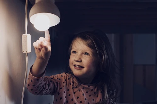 Child looking at a night lamp