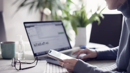 Woman using laptop and mobile