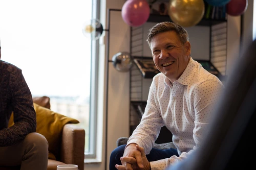 Man sitting down and smiling