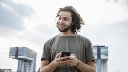 man-holding-phone-smiling