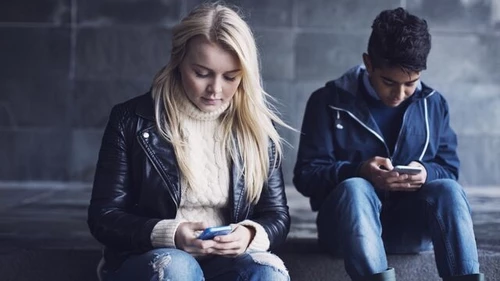 Two people using mobile phones