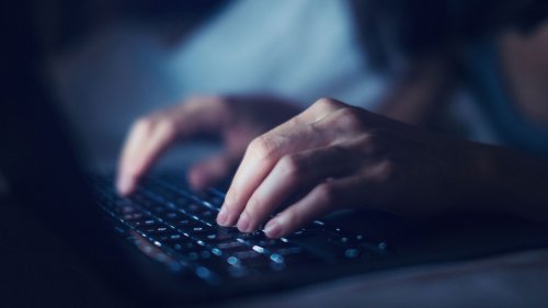 Fingers writing on computer keyboard