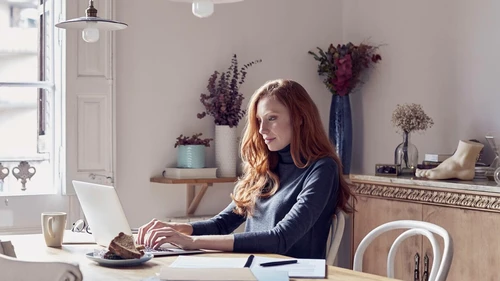 Woman using laptop while working at home