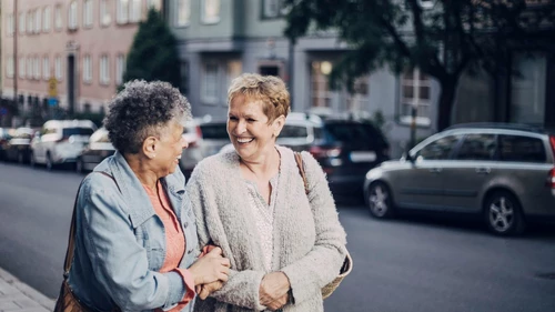 cheerful-female-friends-talking-in-city.jpg