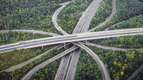 Intersecting highways near trees