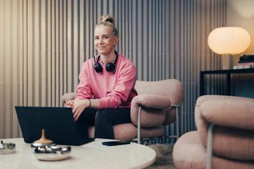 Women smiling and sitting with laptop at the office