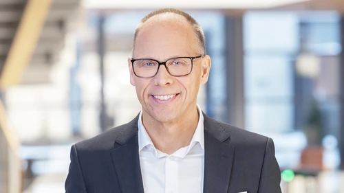 Man with glasses looking into the camera