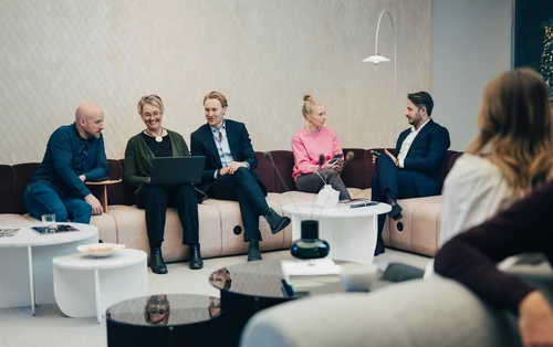 Group of employees sitting at the sofa 