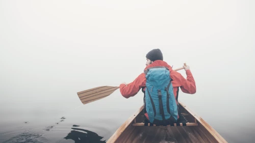 Man canoeing in a foggy weather