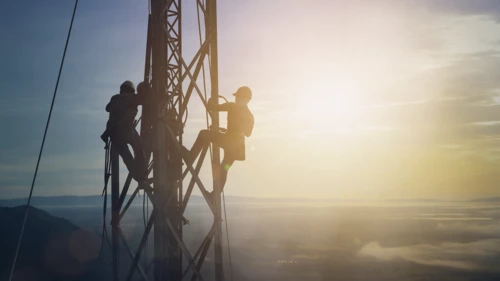 Silhouette electrician work on high ground on electrical grid equipment