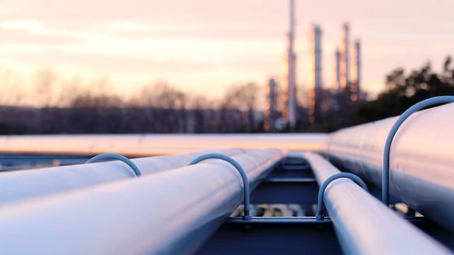 Steel long pipes in oil factory during sunset