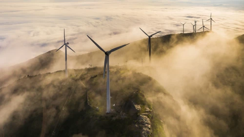 Windmills on mountains in a misty weather