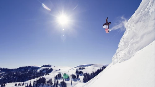 A snowboarder jumping