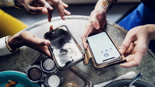 Two people using smart phones
