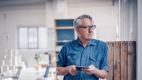 Senior businessman holding tablet