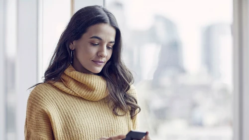 Woman using smart phone at office