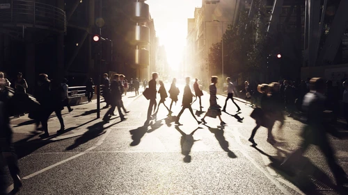 Business people walking through at city at dawn