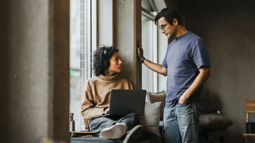 Man and woman talking in window