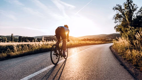Person on bicycle in sunset