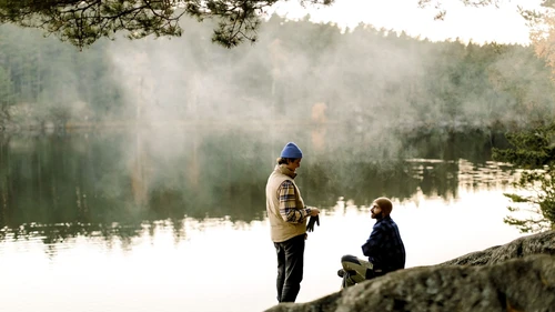 two-men-socializing-next-to-beautiful-lake