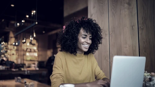 Smiling woman using laptop