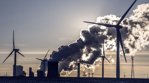 Wind turbines in sunset in front of smoke