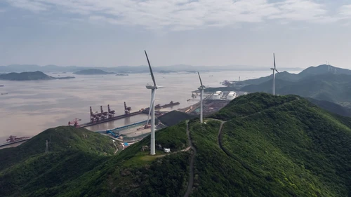 Wind turbines with container terminal in background