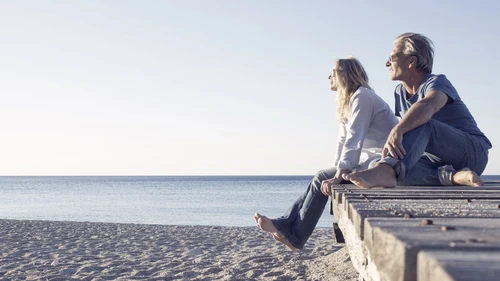 Couple relax on beach boardwalk