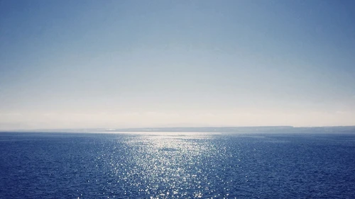 Sea against clear blue sky
