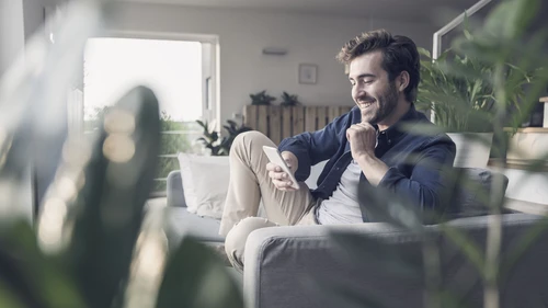Young man sitting on couch