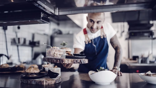 Chef serving burgers in the kitchen