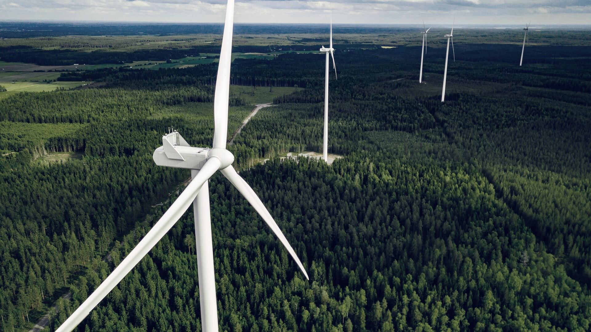 Aerial view of windmills in summer forest in Finland