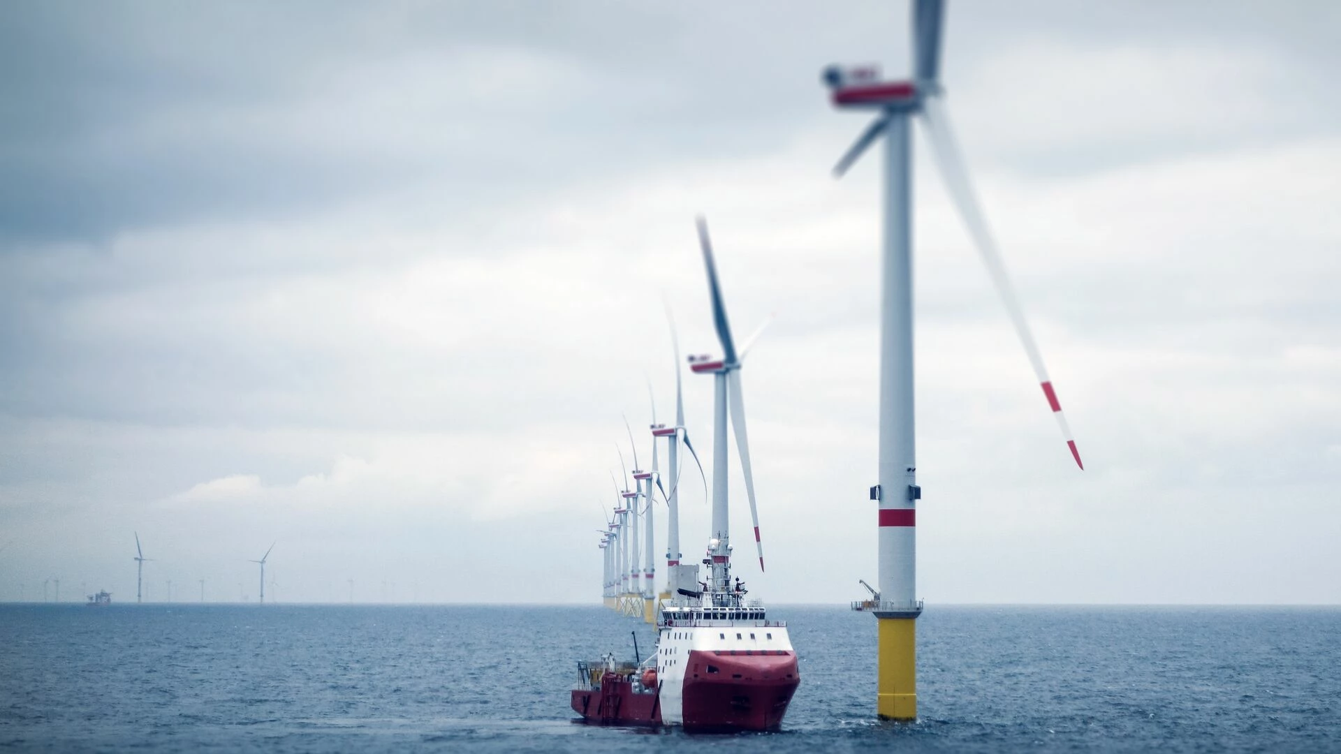 Windmills and tanker in open sea