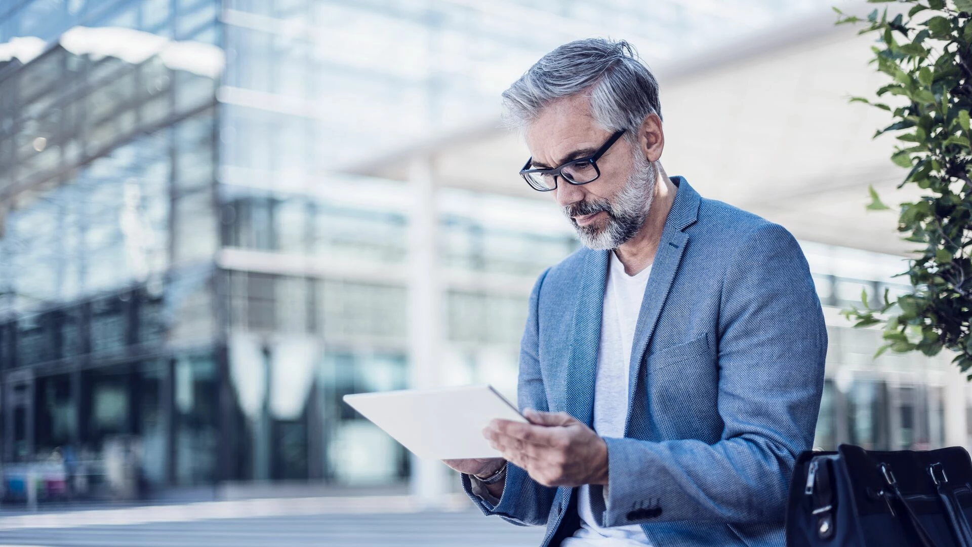 Businessman using tablet outdoors