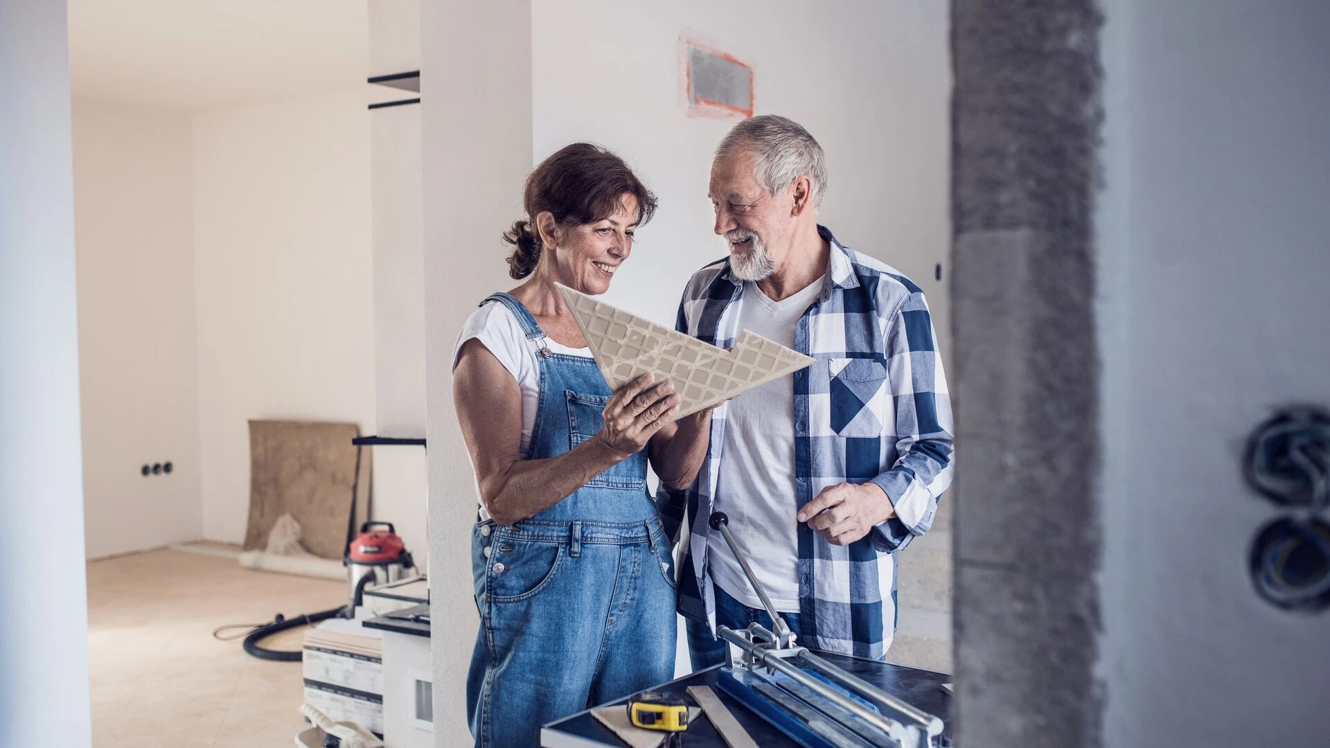 senior-couple-laying-tile-floor-in-new-home