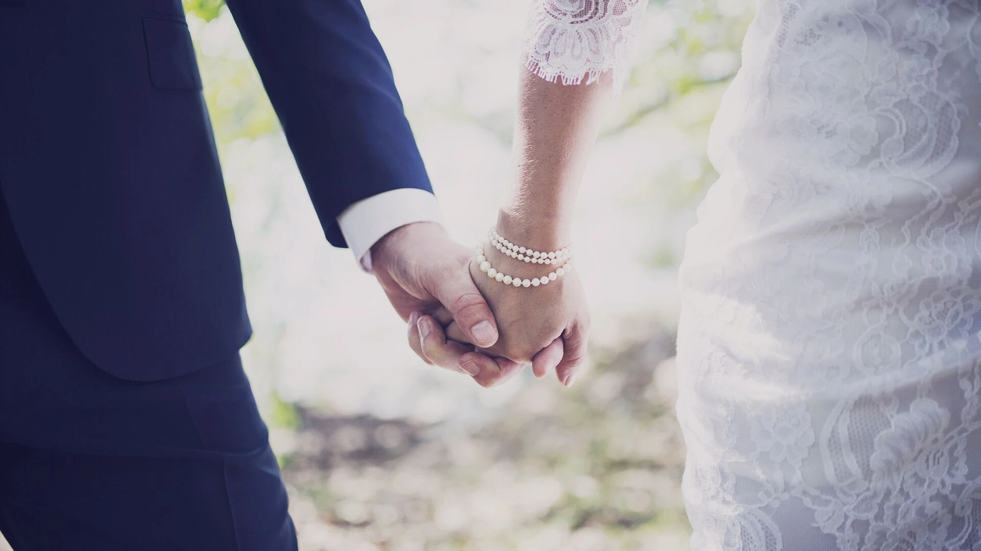 newly-married-couple-holding-hands