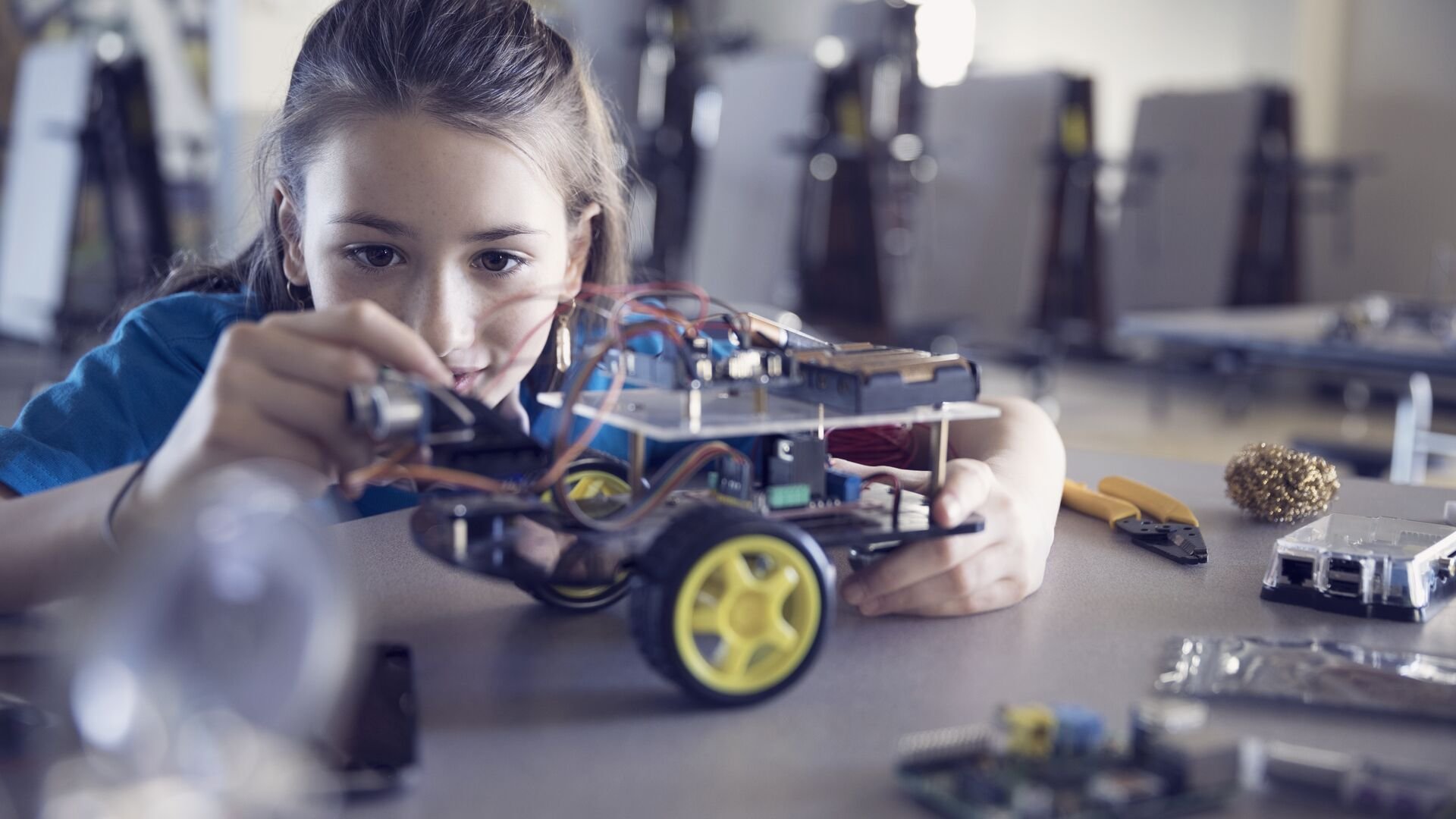 Young girl building robot