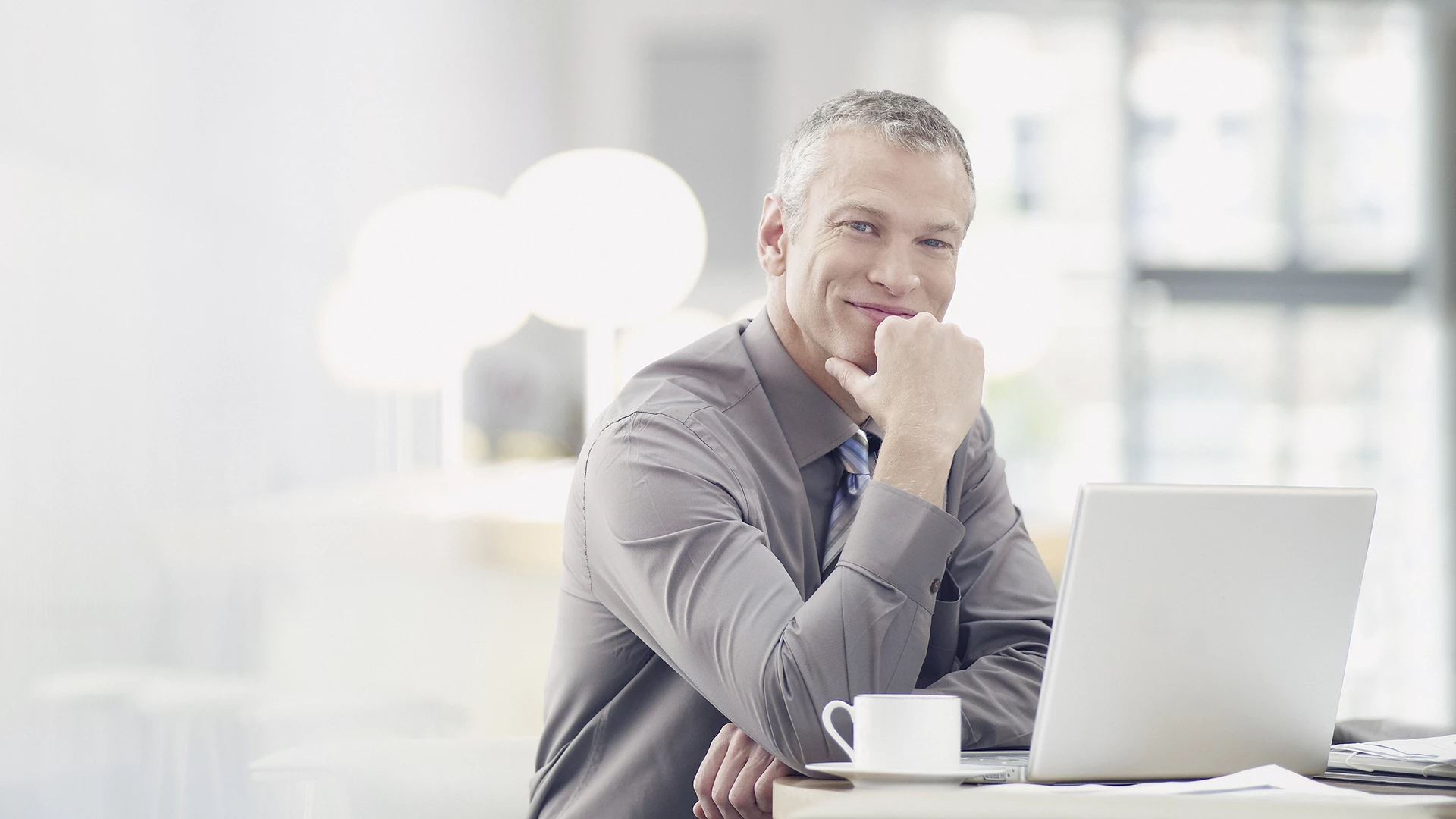 Businessman working on laptop in cafe