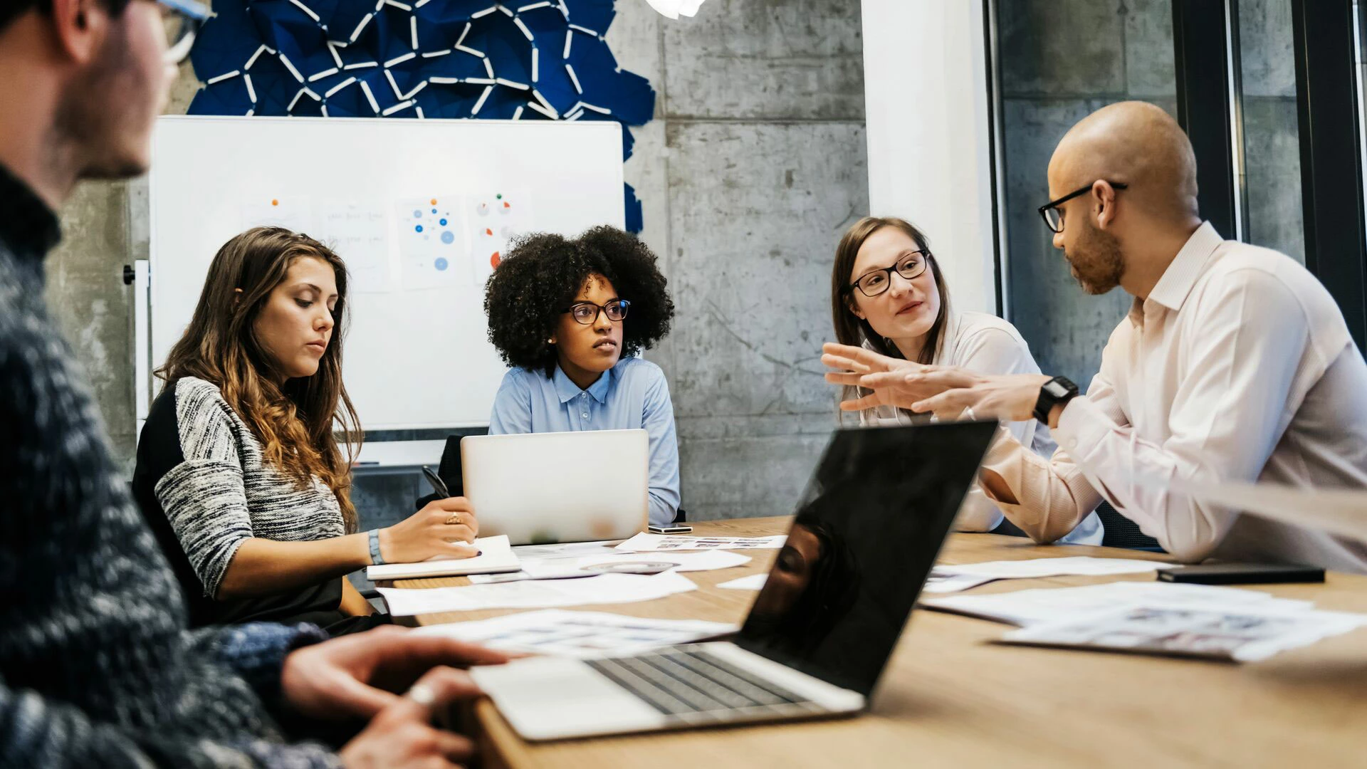 Three women and two men in a business meeting