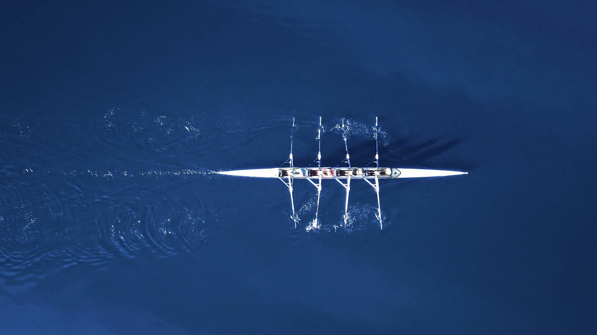Rowing boat surrounded by classic blue water