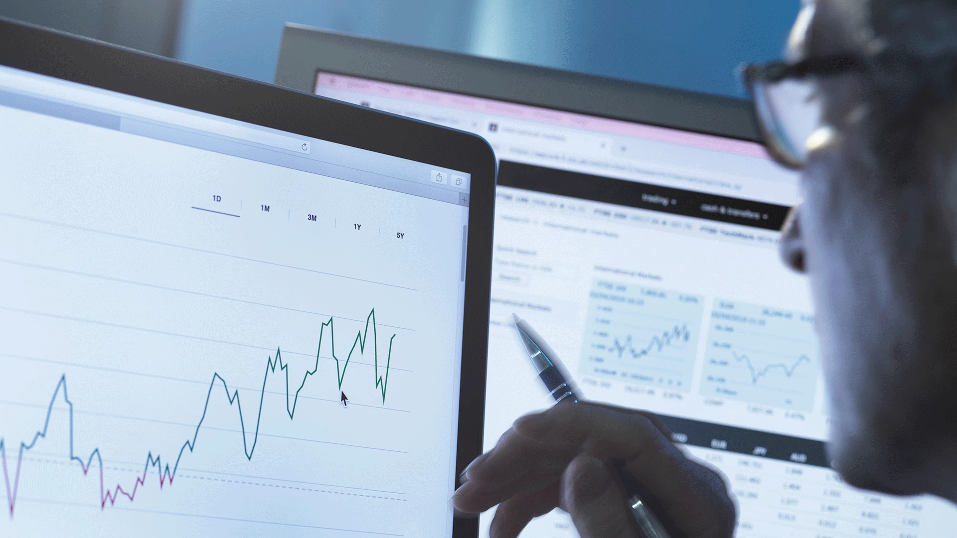 Stock analyst researching share price data graph