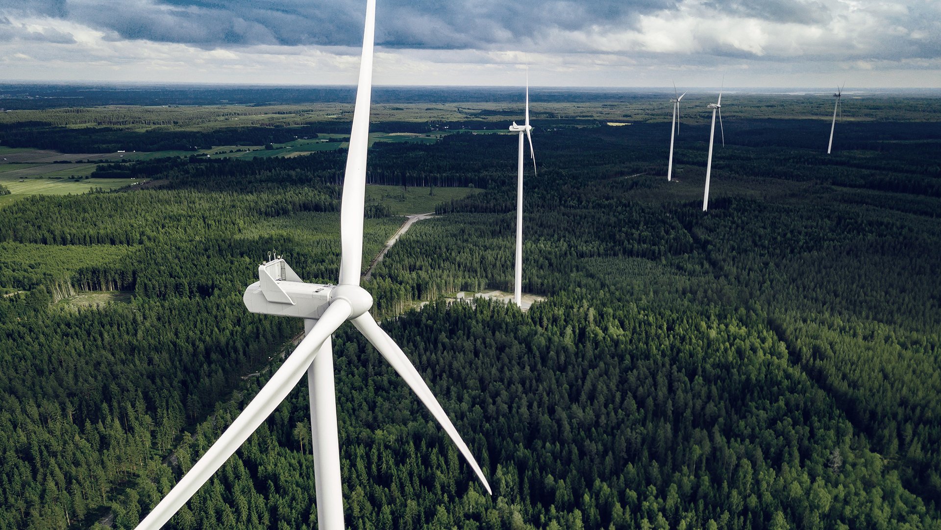 Aerial-view-of-windmills-in-summer-forest-in-Finland