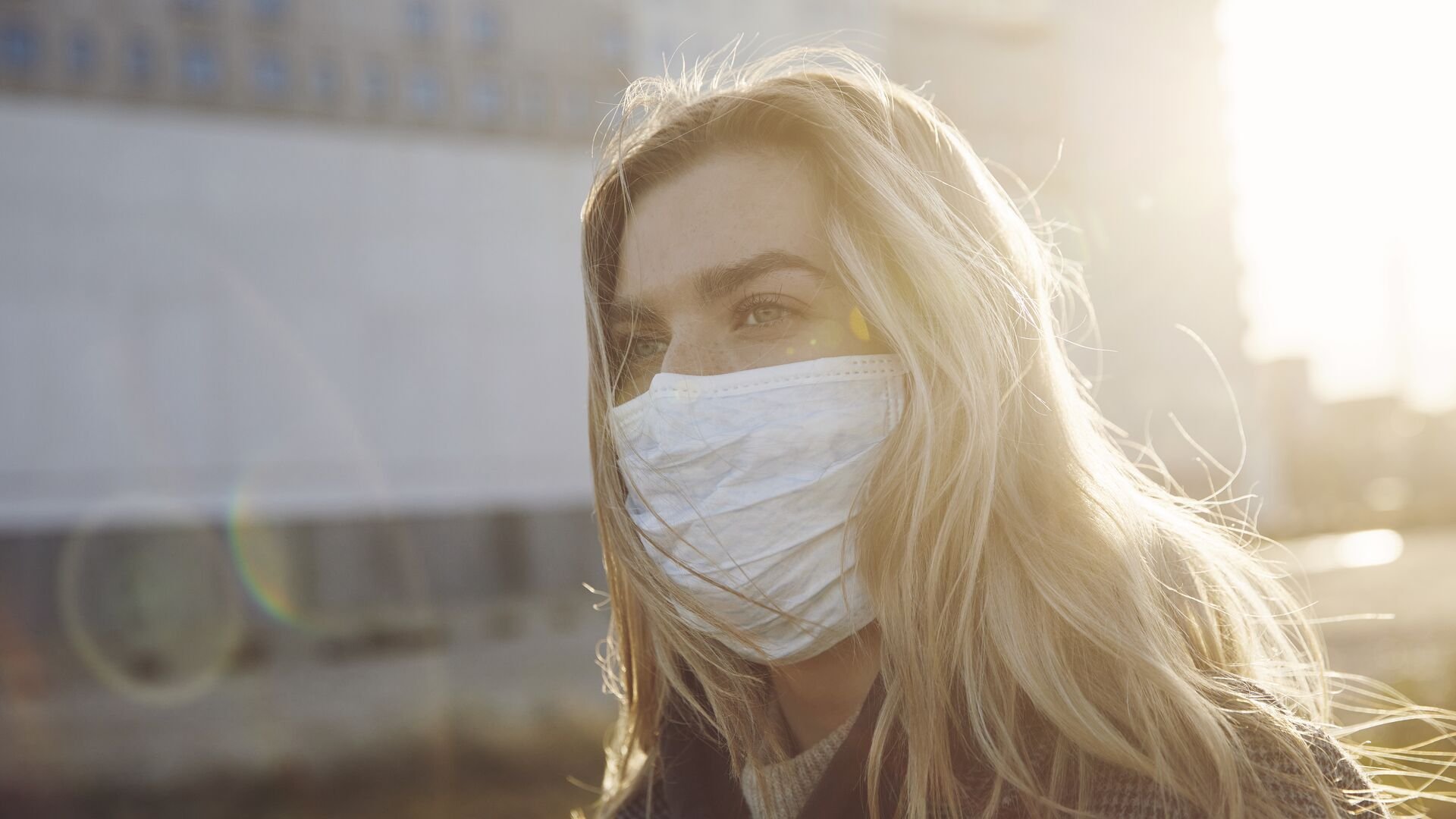Young woman outside wearing a virus protective face