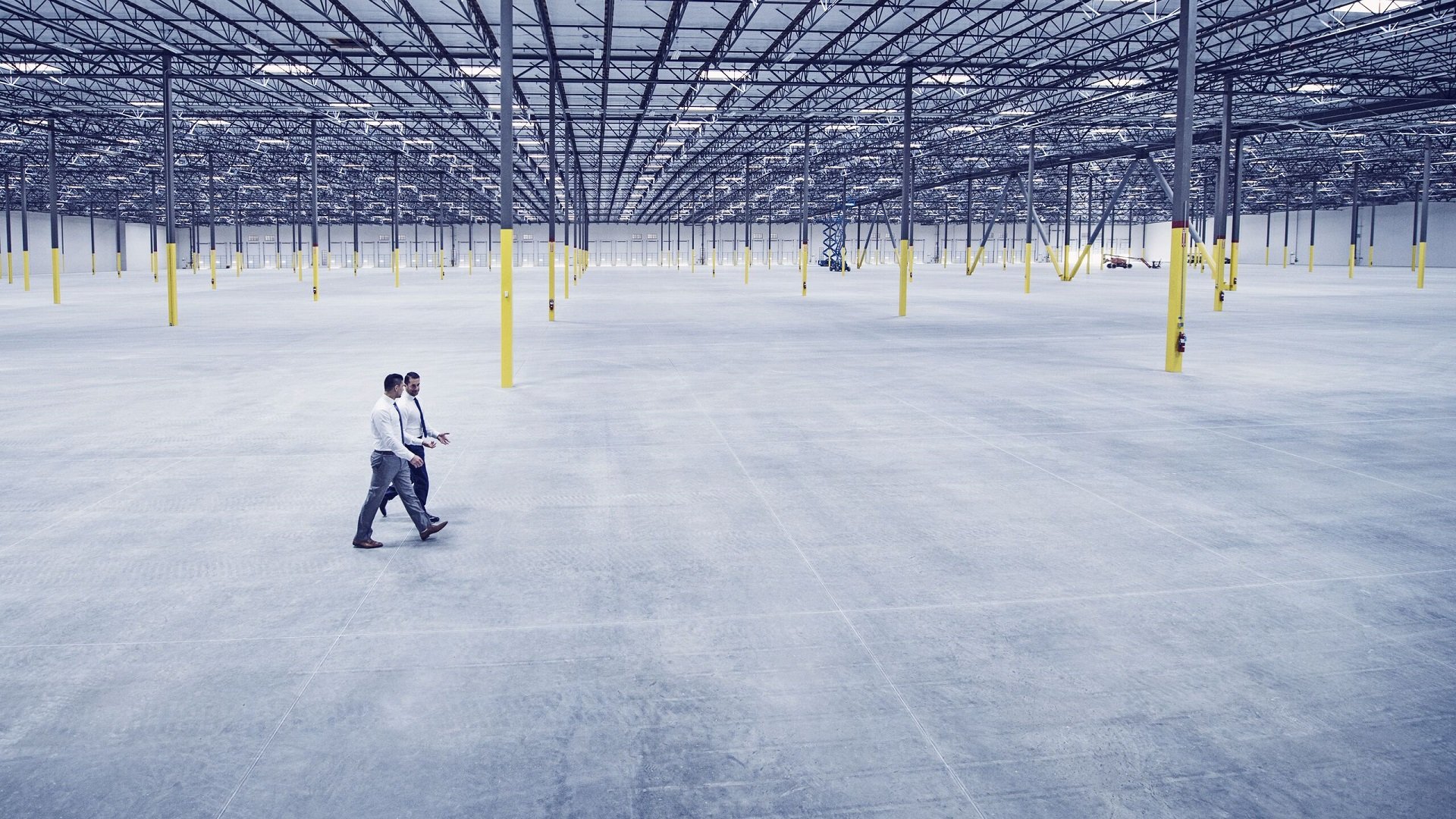 Business men walking in warehouse