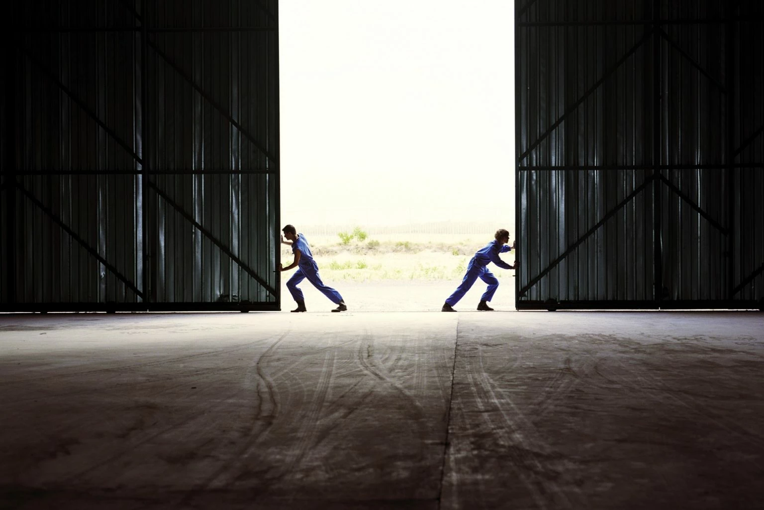 Two farmers opening barndoors