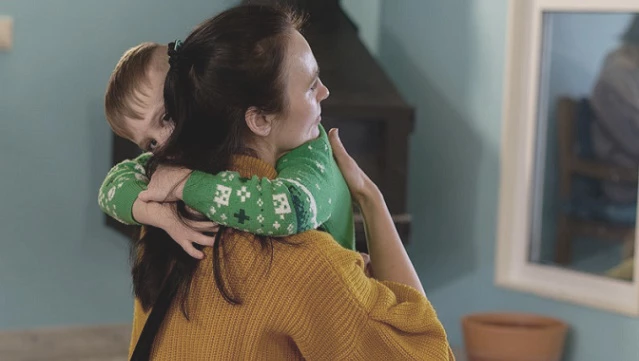 Mom and son hugging 