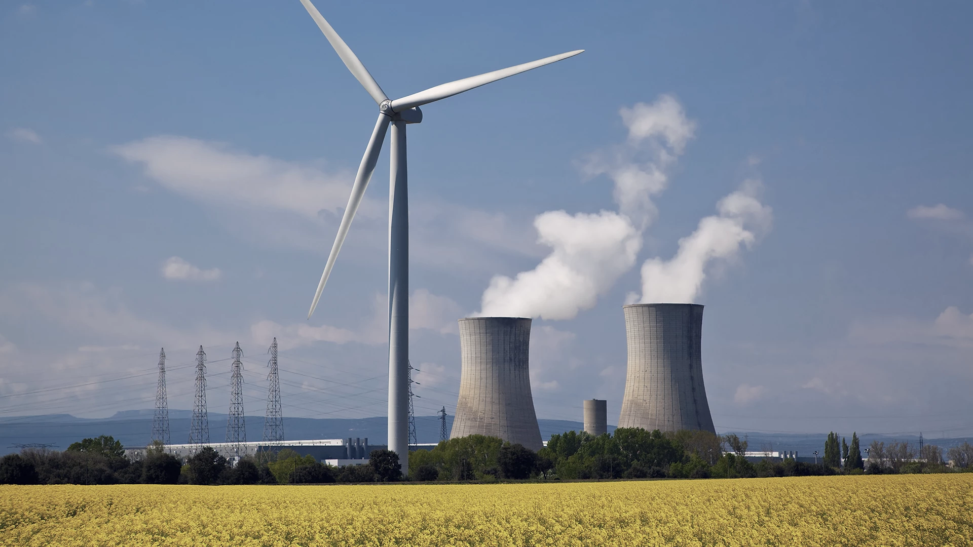 Nuclear power plant behind a windmill