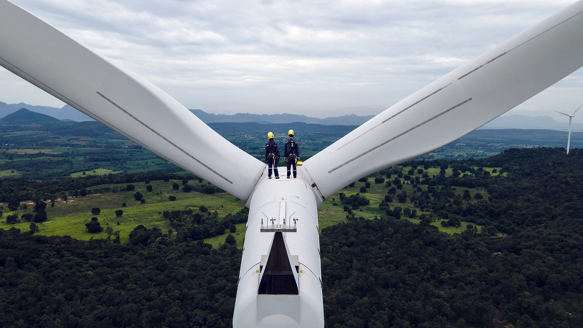 Two men standing on wind field 