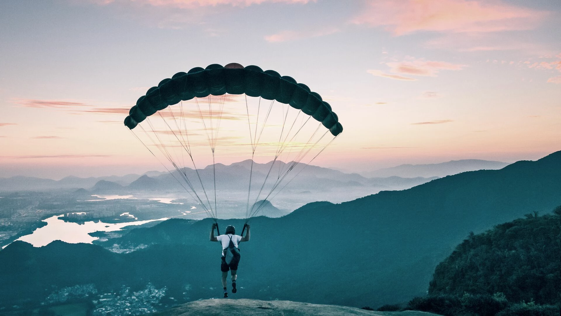 Paraglider taking off from mountain