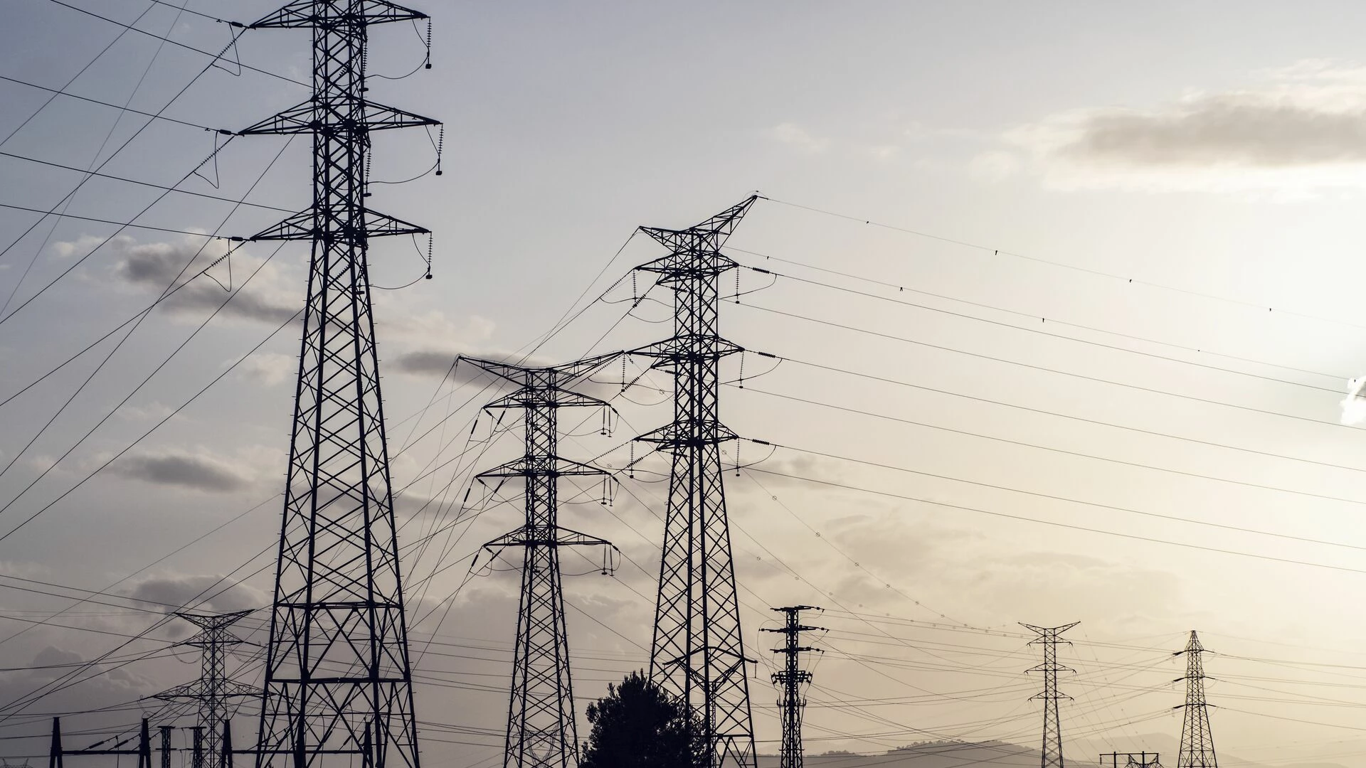 Silhouettes of a group of high-voltage electric towers